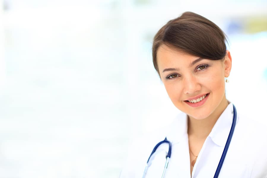 Medical physician doctor woman over blue clinic background